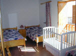 A triple room with baby cot