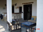 The living room, kitchen and one bedroom are all opening, with double doors, to the large covered terrace, which has a built-in bar and comfortable outside furniture.