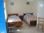 Marias main house twin bedroom with cot and large wardrobes at the other end of the room in Kalavassos Cyprus