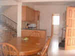 The dining area has a large dining table and chairs to seat seven people.