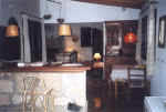 The open plan kitchen has a washing machine, fridge/freezer, gas oven, gas hob and all necessary cutlery.